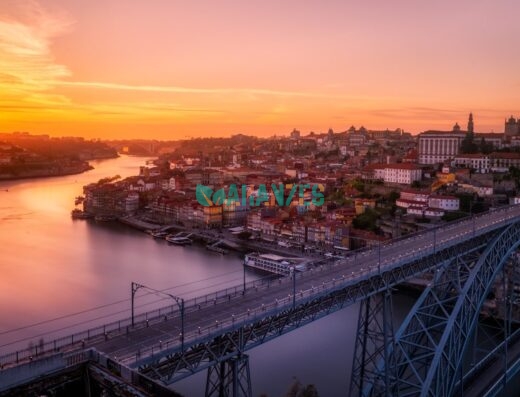 gray bridge near building at sunset